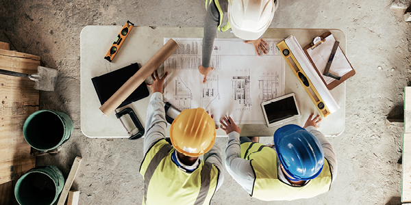 Two commercial project managers analyzing resources for their project