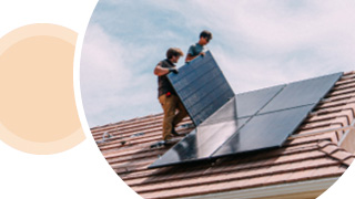Image of people mounting solar panels on a roof