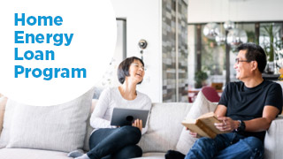 Photo of people on a couch with the text "Home Energy Loan Program"