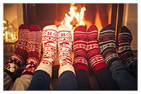 Photo of people wearing socks by the fireplace